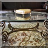 F59. Wrought metal table with beveled glass top. 